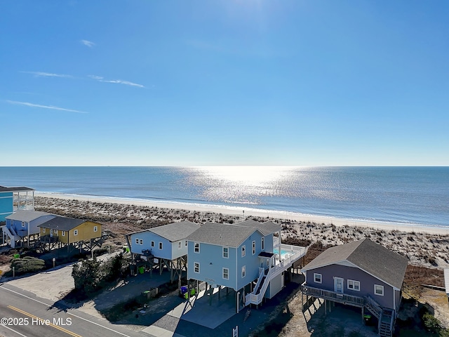 drone / aerial view featuring a view of the beach and a water view