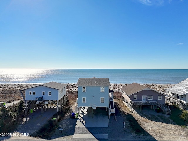 birds eye view of property with a beach view and a water view