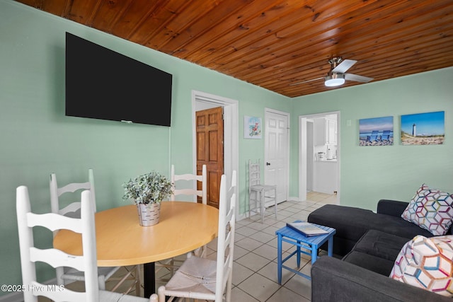 living room featuring ceiling fan, light tile patterned floors, and wood ceiling