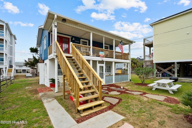 rear view of property with a lawn