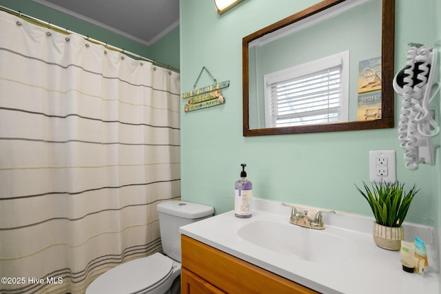 bathroom with a shower with shower curtain, vanity, toilet, and ornamental molding