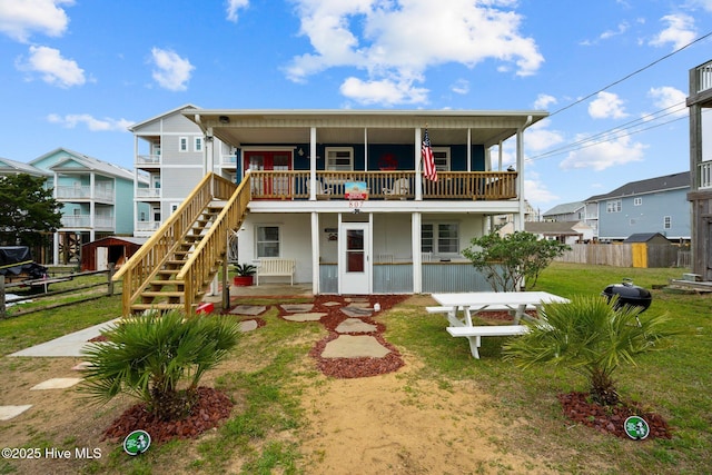 view of front facade with a balcony and a front lawn