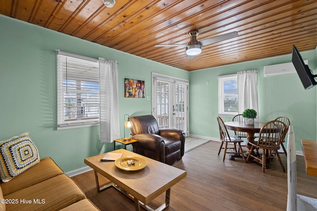 living room featuring ceiling fan, wood-type flooring, an AC wall unit, and wood ceiling