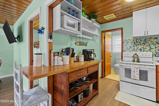 kitchen featuring white appliances, backsplash, white cabinets, light hardwood / wood-style floors, and wood ceiling