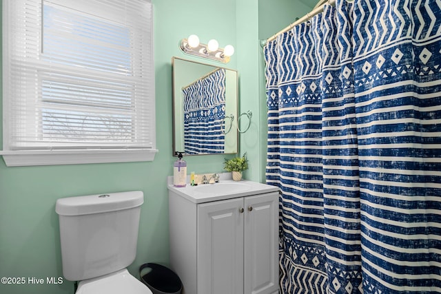 bathroom with vanity, toilet, and walk in shower