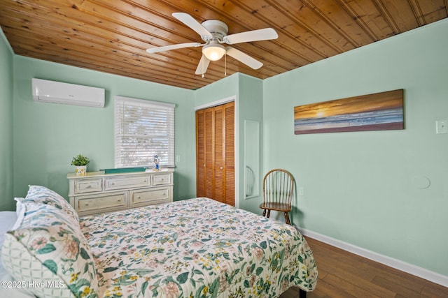 bedroom featuring ceiling fan, a wall mounted air conditioner, hardwood / wood-style floors, a closet, and wood ceiling