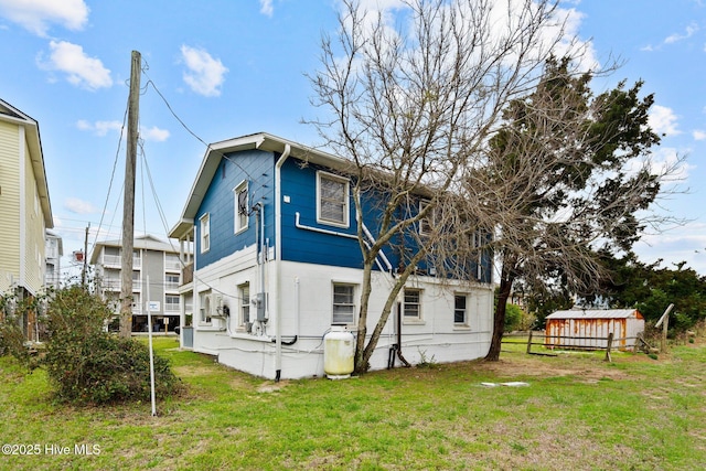 rear view of property featuring a yard