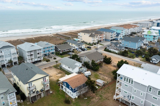 bird's eye view featuring a water view and a beach view