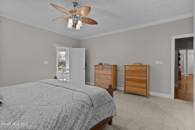 bedroom with ceiling fan, carpet floors, a textured ceiling, and ornamental molding