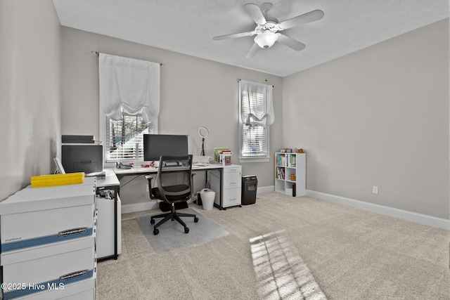 carpeted home office with ceiling fan