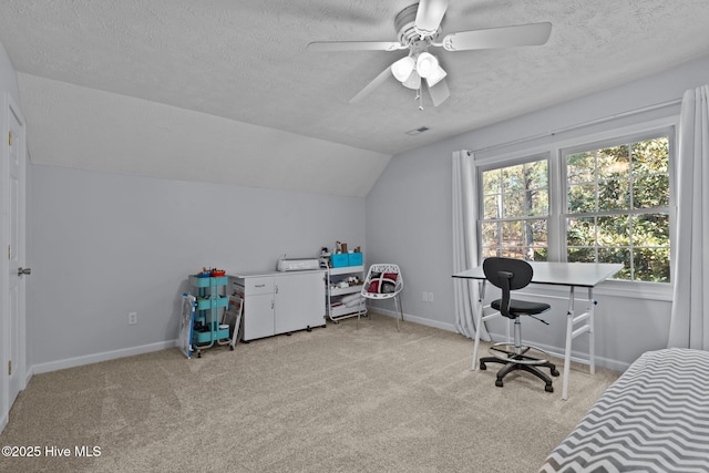 interior space with ceiling fan, lofted ceiling, and a textured ceiling