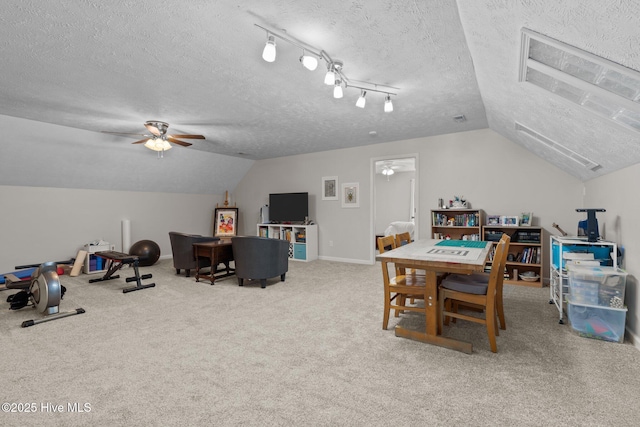 game room with ceiling fan, light colored carpet, and a textured ceiling