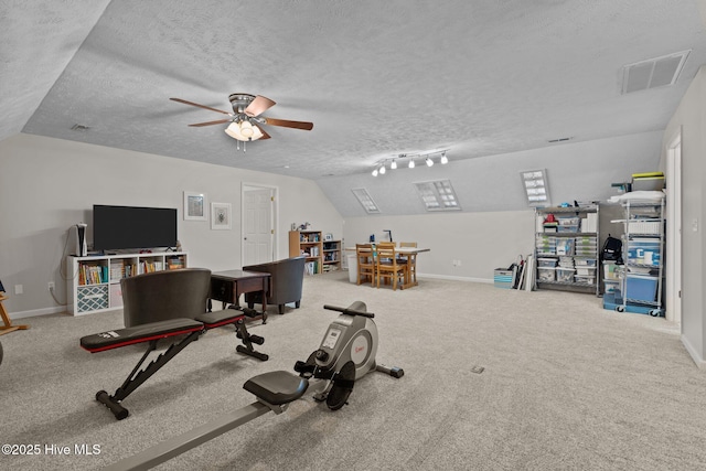 workout area with carpet flooring, ceiling fan, a textured ceiling, track lighting, and vaulted ceiling