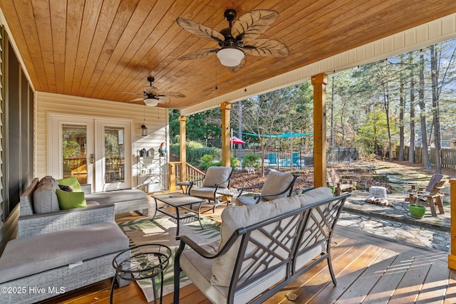 wooden deck with french doors, an outdoor living space, and ceiling fan