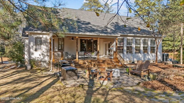 back of property with ceiling fan