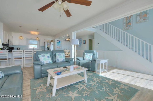 living room featuring ceiling fan and light hardwood / wood-style flooring