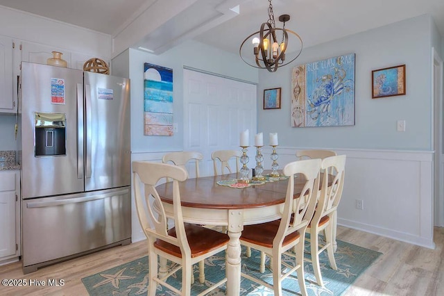 dining room featuring a notable chandelier and light hardwood / wood-style flooring