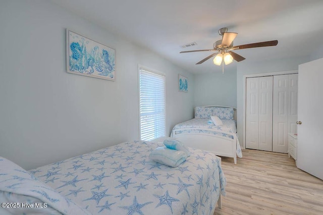 bedroom featuring a closet, ceiling fan, and light wood-type flooring