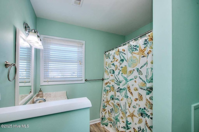 bathroom featuring wood-type flooring, vanity, and a shower with shower curtain