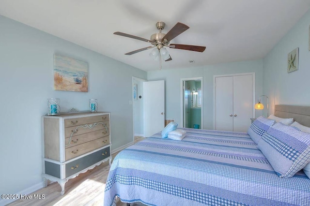 bedroom featuring ceiling fan, ensuite bathroom, a closet, and wood-type flooring