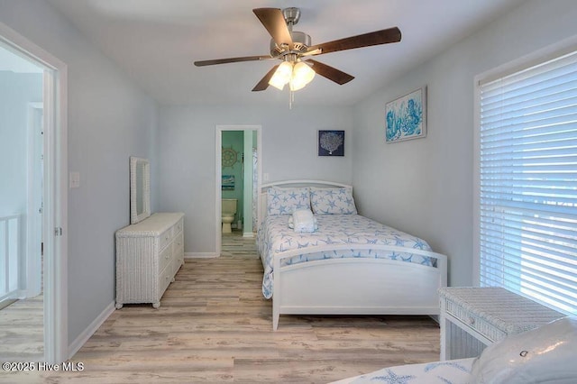 bedroom with ceiling fan, light hardwood / wood-style floors, and ensuite bath