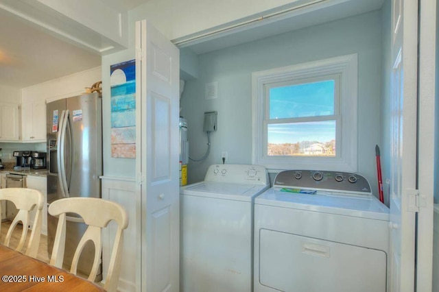 laundry room with washer and dryer and hardwood / wood-style floors