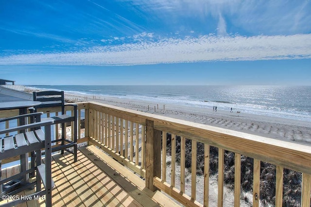 surrounding community featuring a beach view and a water view