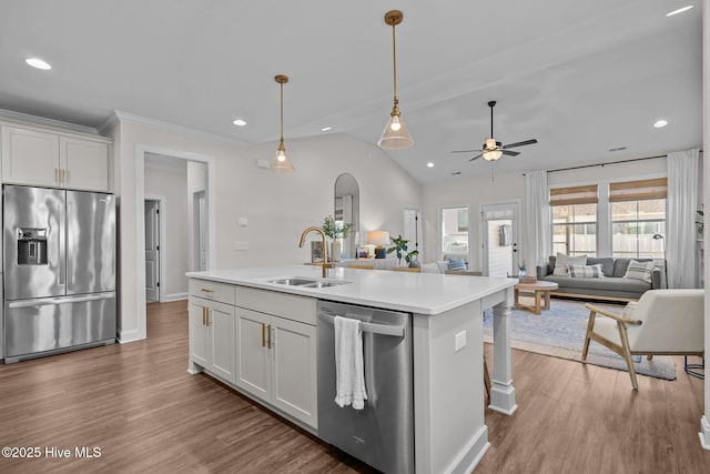 kitchen with sink, white cabinetry, stainless steel appliances, and a kitchen island with sink