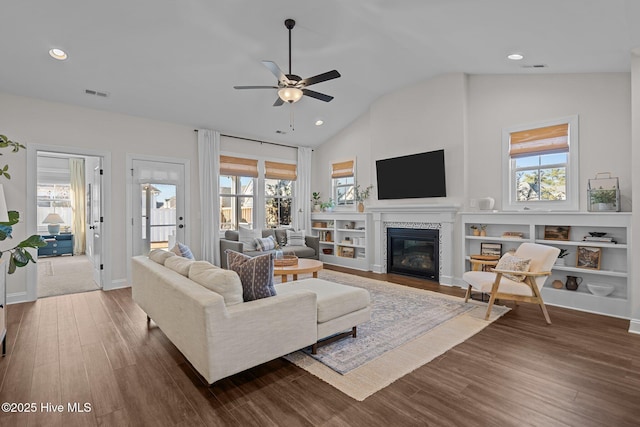 living room with dark hardwood / wood-style floors, ceiling fan, and lofted ceiling