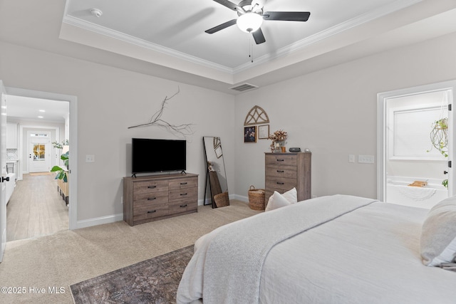 bedroom featuring ceiling fan, light colored carpet, ornamental molding, and a tray ceiling