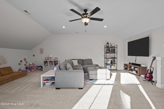 carpeted living room with ceiling fan and vaulted ceiling