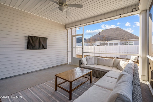 sunroom / solarium with a mountain view and ceiling fan