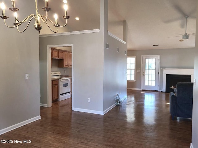 unfurnished living room with ceiling fan with notable chandelier and dark wood-type flooring