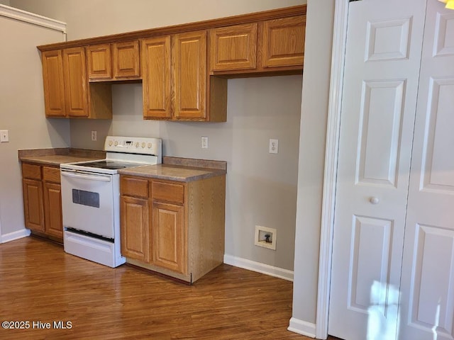 kitchen featuring white electric range oven and dark hardwood / wood-style floors