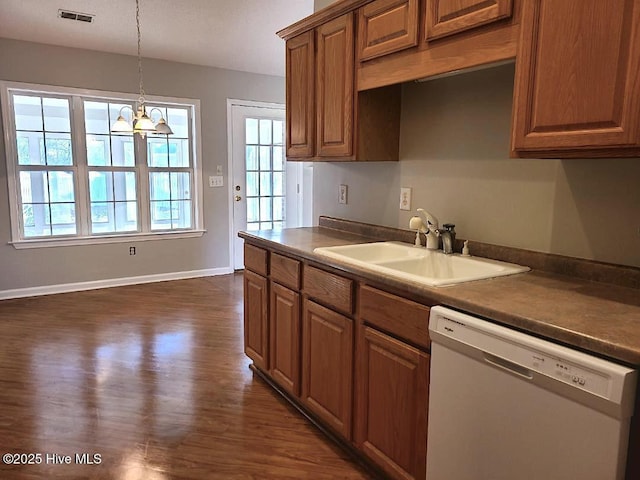 kitchen with white dishwasher, a notable chandelier, a healthy amount of sunlight, and sink