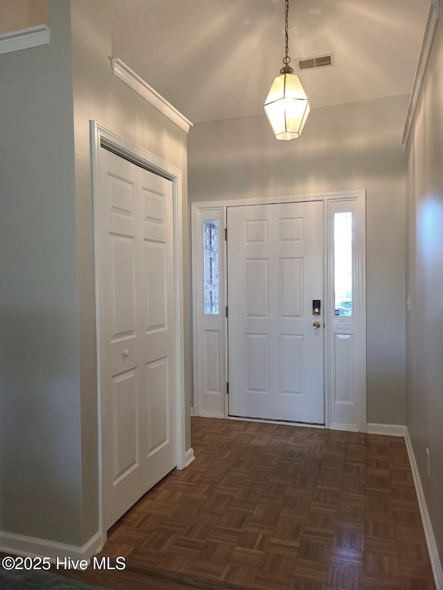 foyer with dark parquet flooring