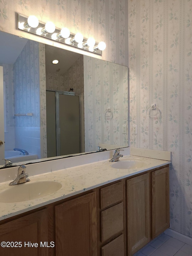 bathroom with tile patterned floors, vanity, and a shower with door