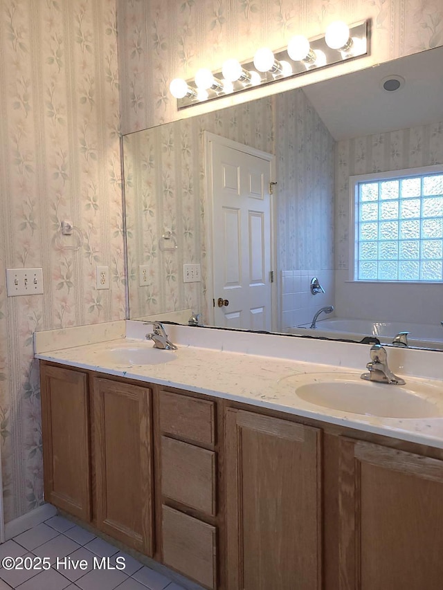 bathroom with tile patterned flooring, vanity, and a bathing tub