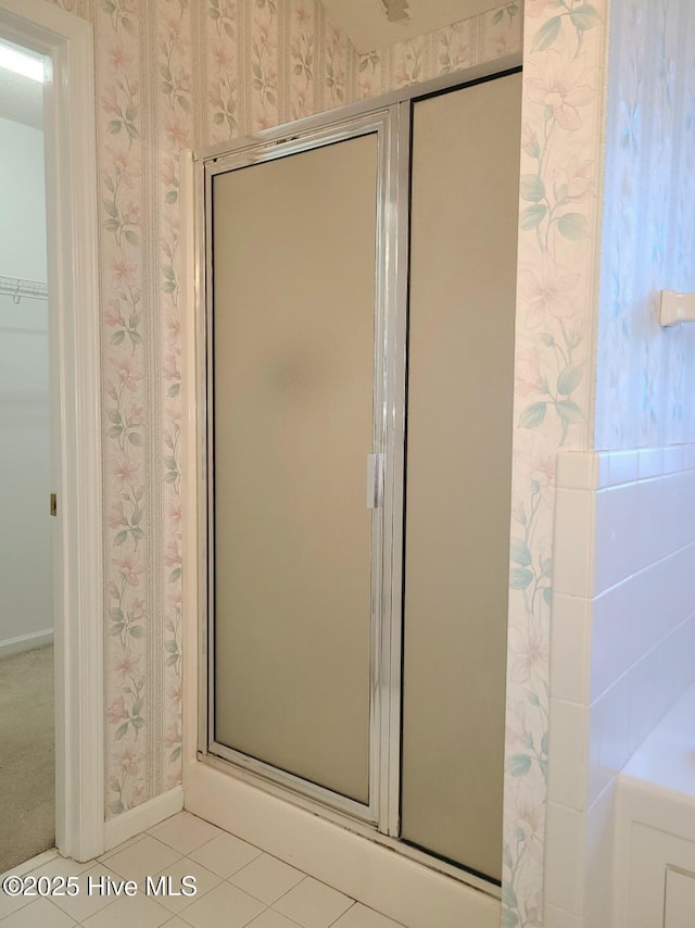 bathroom with tile patterned floors and walk in shower