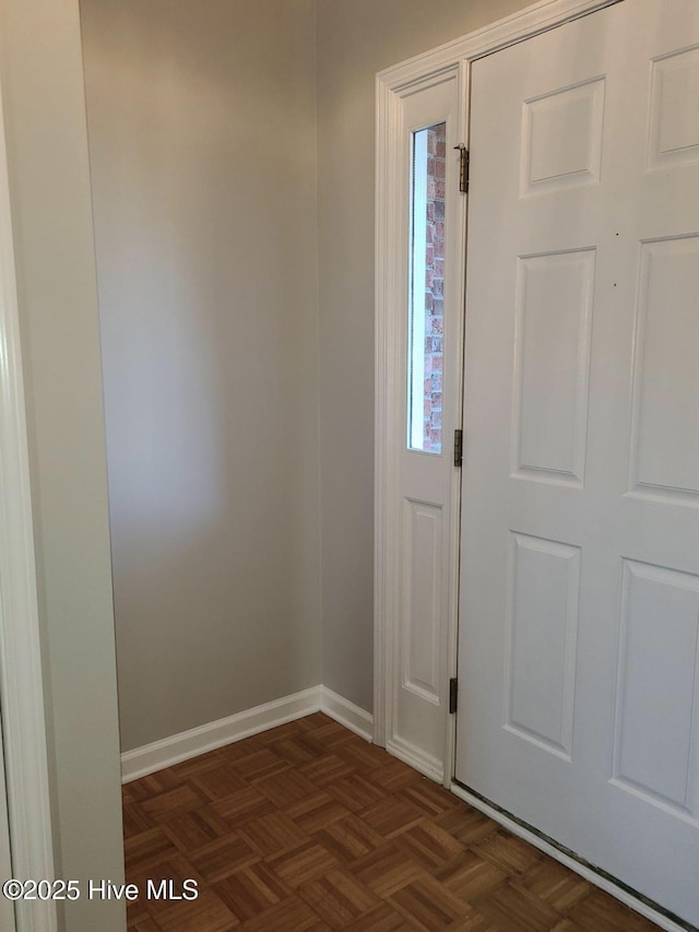 foyer with dark parquet floors