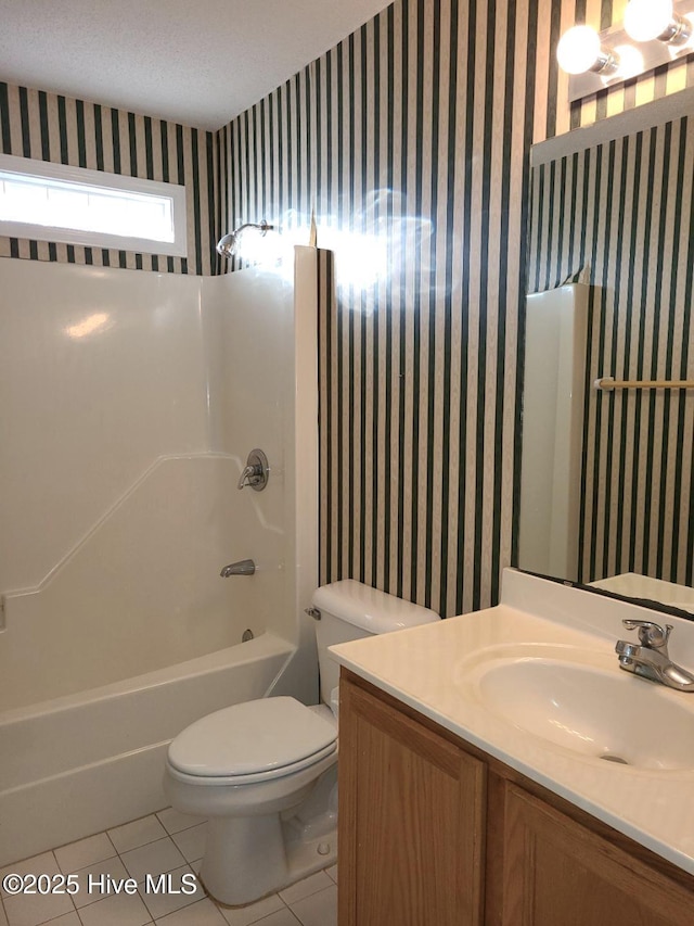 full bathroom with tile patterned flooring, vanity, toilet, and shower / bath combination