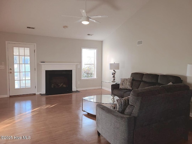 living room featuring hardwood / wood-style flooring, ceiling fan, and lofted ceiling