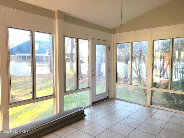 unfurnished sunroom featuring lofted ceiling