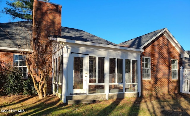 rear view of property with a sunroom