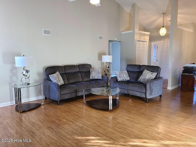 living room featuring hardwood / wood-style floors, high vaulted ceiling, and ceiling fan