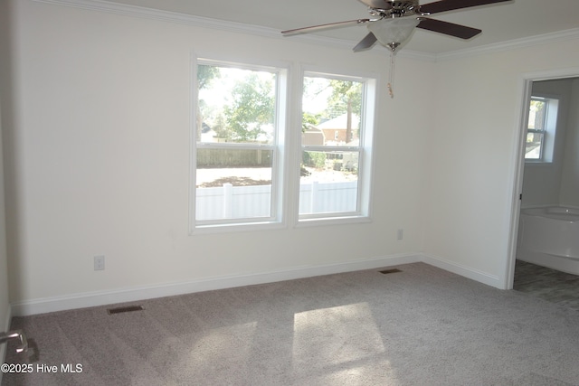 carpeted spare room with ceiling fan and crown molding