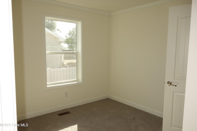 unfurnished room featuring dark colored carpet and crown molding