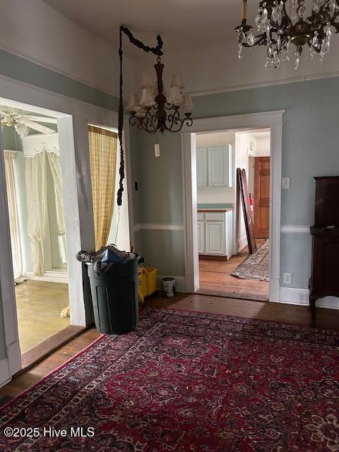 unfurnished dining area featuring a notable chandelier and hardwood / wood-style flooring