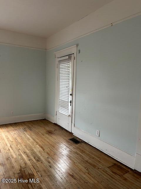 empty room with hardwood / wood-style flooring