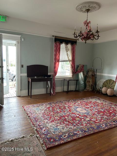 miscellaneous room with hardwood / wood-style flooring, plenty of natural light, french doors, and a chandelier